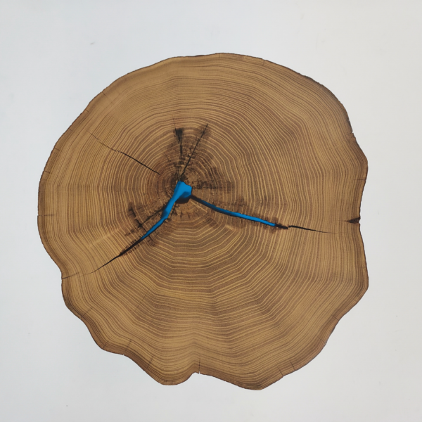 Wood slice table with blue epoxy resin and acacia wood slice